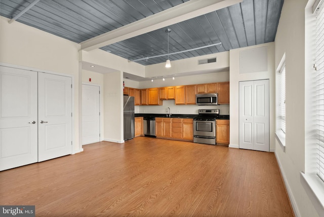 kitchen with hanging light fixtures, sink, appliances with stainless steel finishes, light hardwood / wood-style floors, and wood ceiling