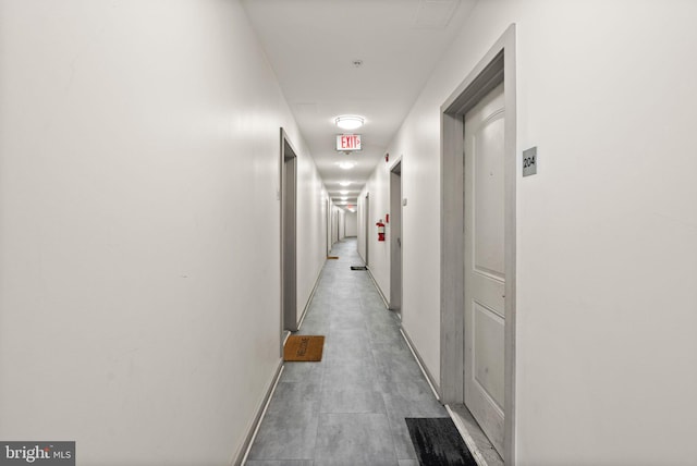 hall featuring baseboards