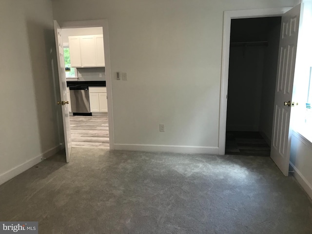 empty room with baseboards and light carpet