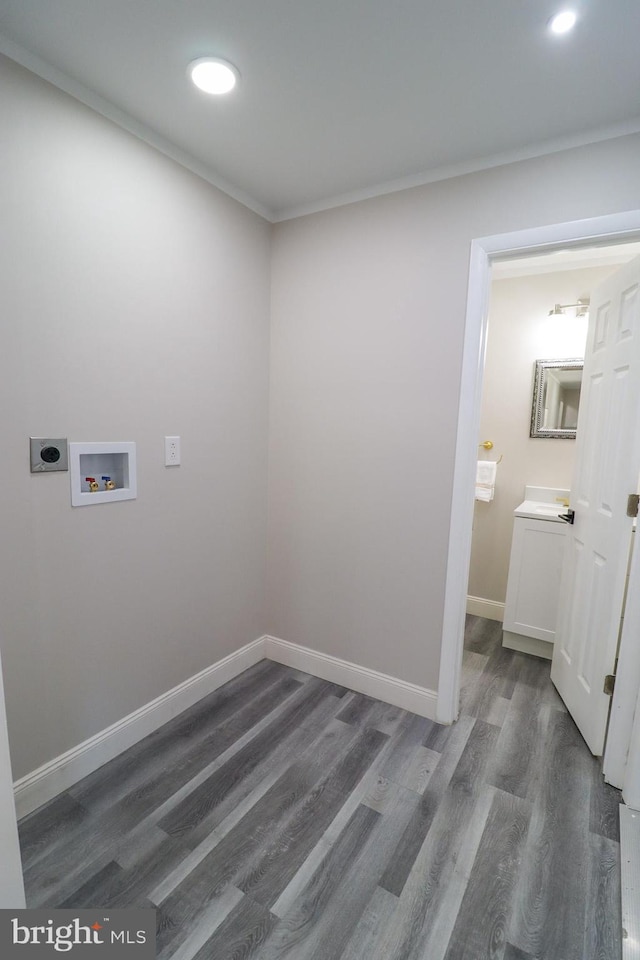 washroom with dark wood-type flooring, washer hookup, and hookup for an electric dryer