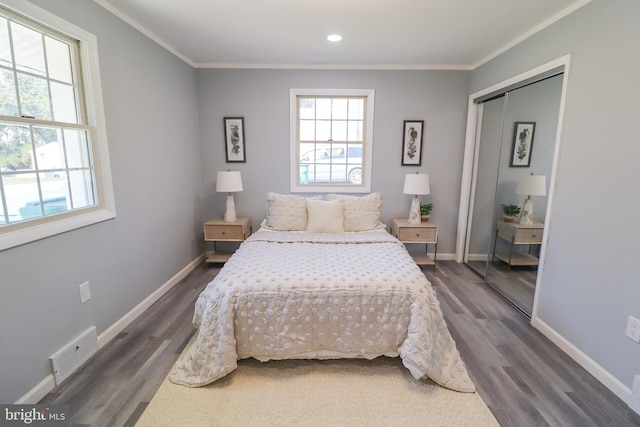 bedroom with ornamental molding, dark hardwood / wood-style floors, and a closet