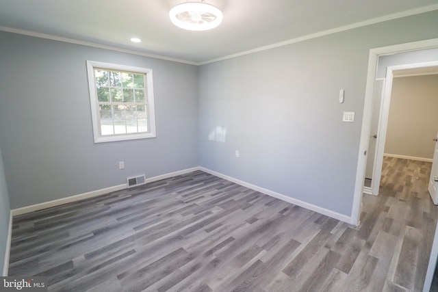 unfurnished room with crown molding and light hardwood / wood-style flooring