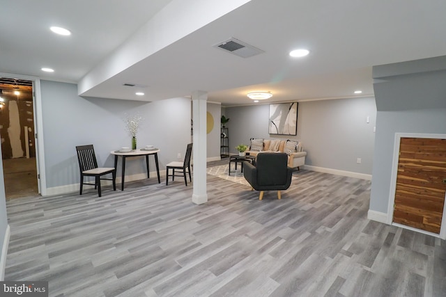 basement with light hardwood / wood-style floors