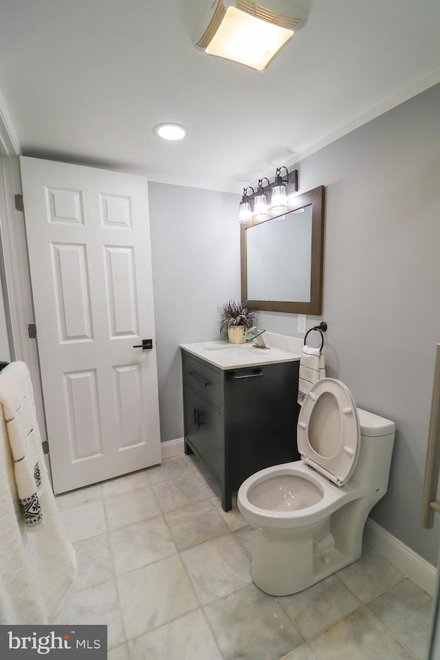 bathroom featuring tile patterned floors, toilet, and vanity