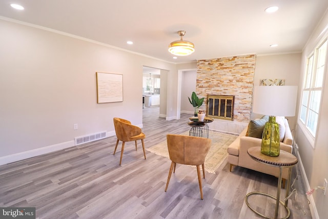 living room with a wealth of natural light, wood-type flooring, and a fireplace