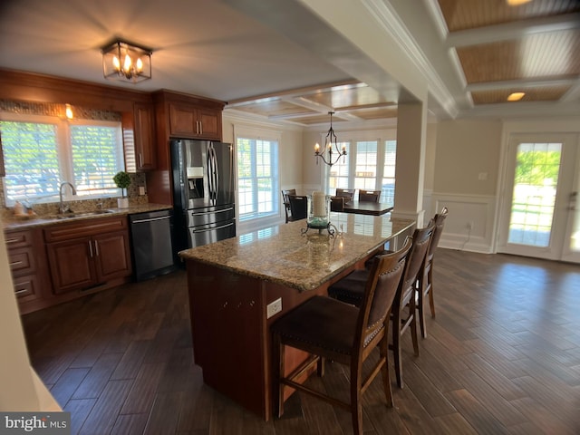 kitchen featuring dark wood-type flooring, a healthy amount of sunlight, appliances with stainless steel finishes, and sink