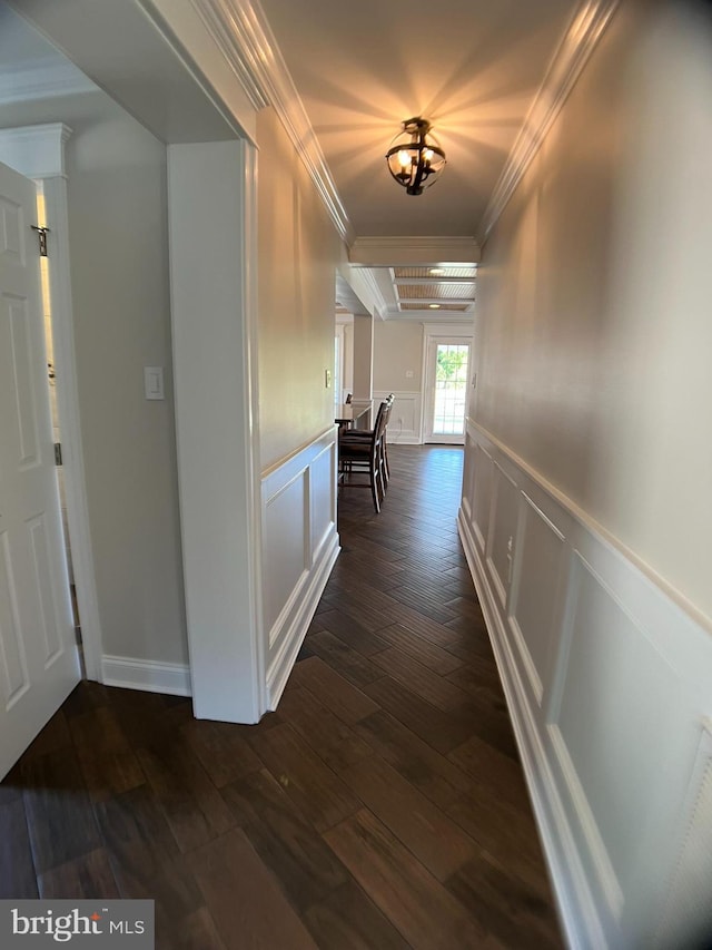 hall with ornamental molding, a chandelier, and dark hardwood / wood-style flooring