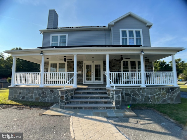 farmhouse featuring a porch, ceiling fan, and french doors