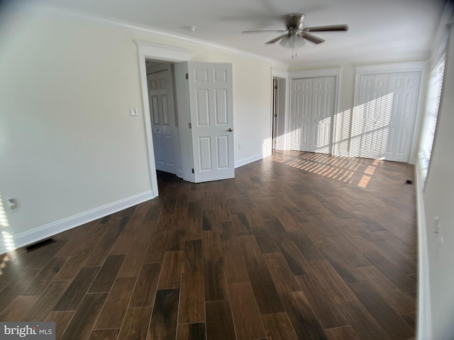 spare room with dark hardwood / wood-style flooring and ceiling fan