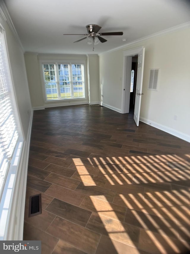 unfurnished room with ceiling fan, ornamental molding, and dark hardwood / wood-style flooring