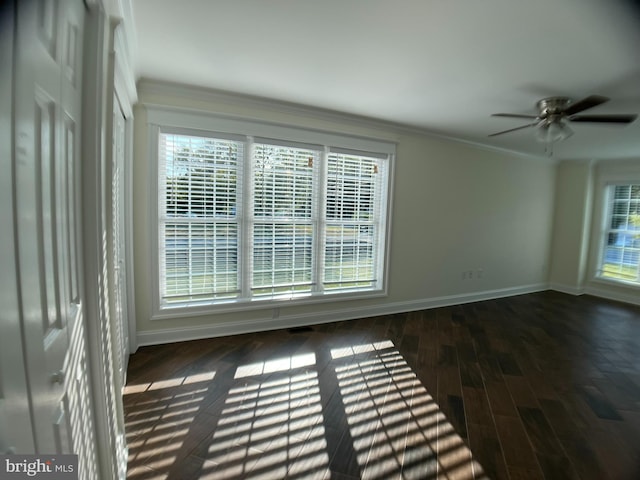 unfurnished room featuring crown molding, dark hardwood / wood-style flooring, plenty of natural light, and ceiling fan