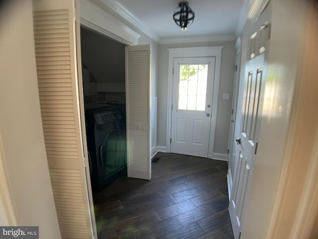 doorway with dark wood-type flooring, washer / dryer, and crown molding