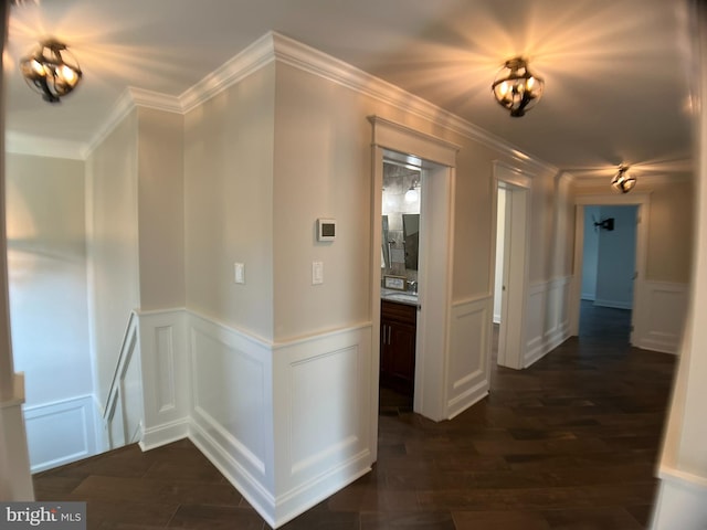 hall featuring dark wood-type flooring and ornamental molding