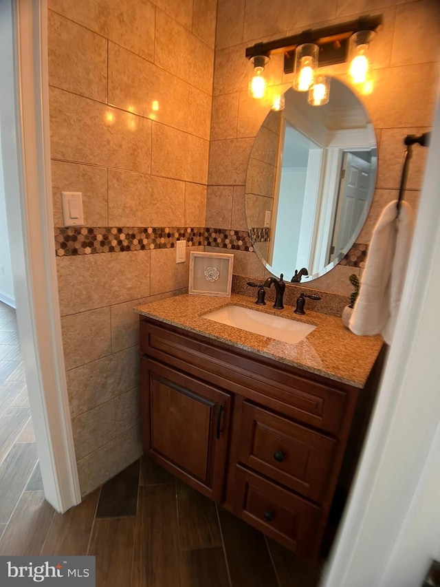 bathroom with vanity and tile walls