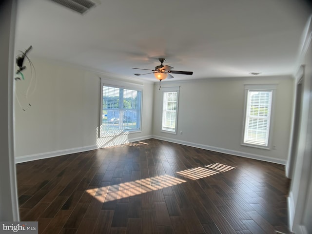 empty room featuring ceiling fan, dark hardwood / wood-style floors, and crown molding