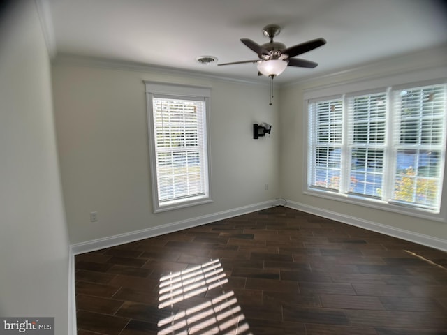 empty room featuring ceiling fan, ornamental molding, and dark hardwood / wood-style floors