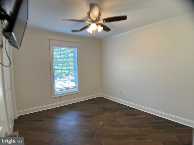 empty room featuring dark wood-type flooring, ceiling fan, and ornamental molding