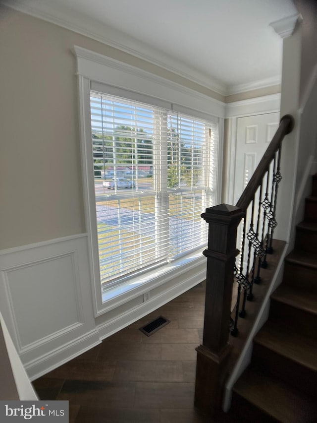 stairs featuring ornamental molding and hardwood / wood-style floors