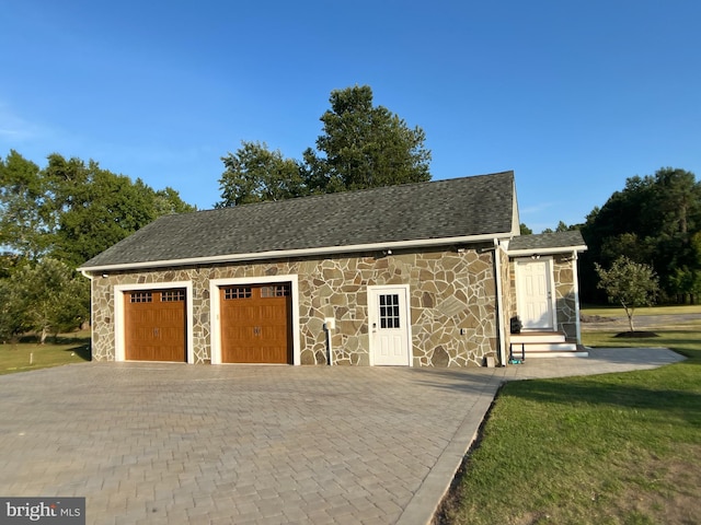 garage featuring a yard