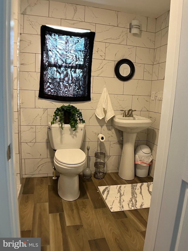 bathroom featuring toilet, hardwood / wood-style flooring, and sink