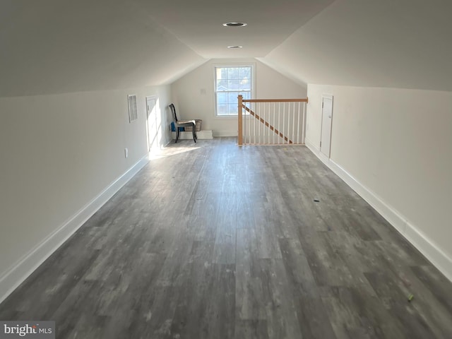 bonus room featuring vaulted ceiling and dark hardwood / wood-style floors