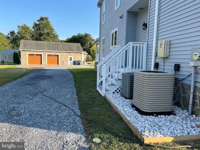 view of side of property featuring a lawn and central AC unit