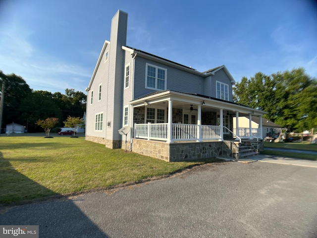 view of front of property with a porch and a front lawn