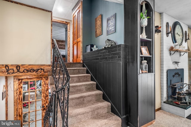 stairs featuring baseboards and carpet