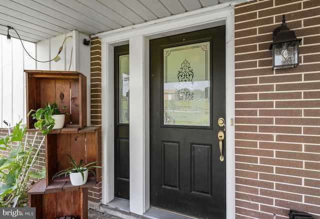 entrance to property with brick siding