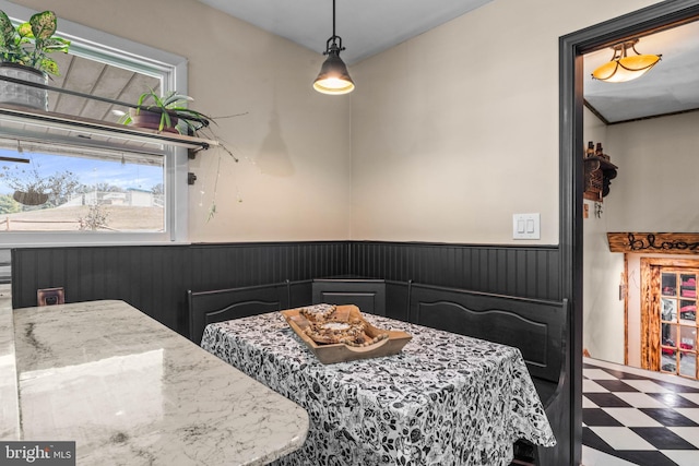 dining room featuring tile patterned floors and wainscoting