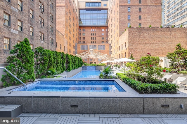 view of swimming pool with a community hot tub