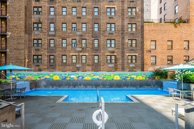 community pool with a patio area