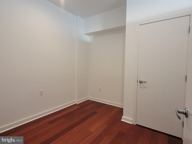 interior space featuring dark wood-style floors and baseboards