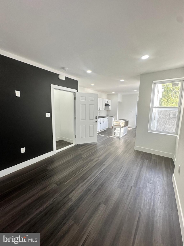 unfurnished living room featuring dark hardwood / wood-style floors