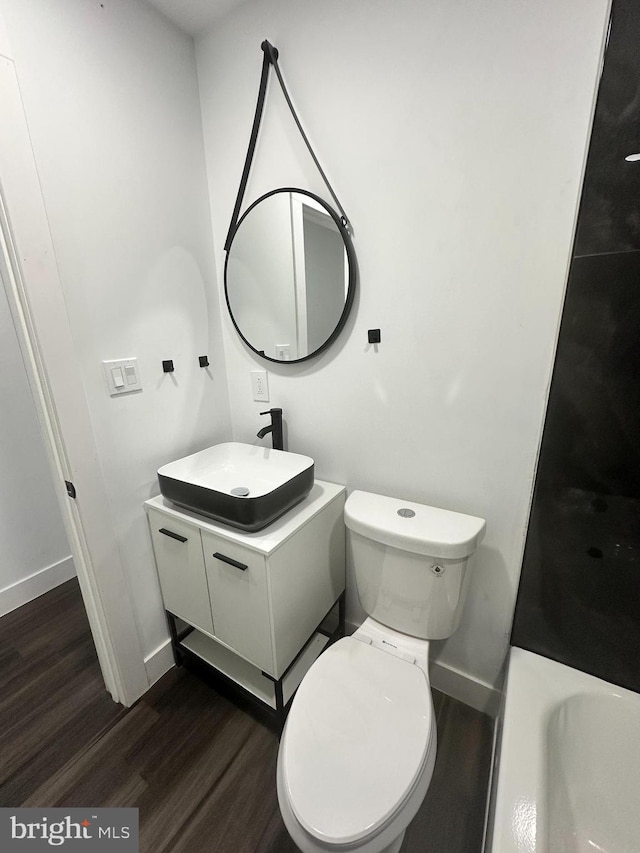 bathroom with vanity, hardwood / wood-style flooring, and toilet