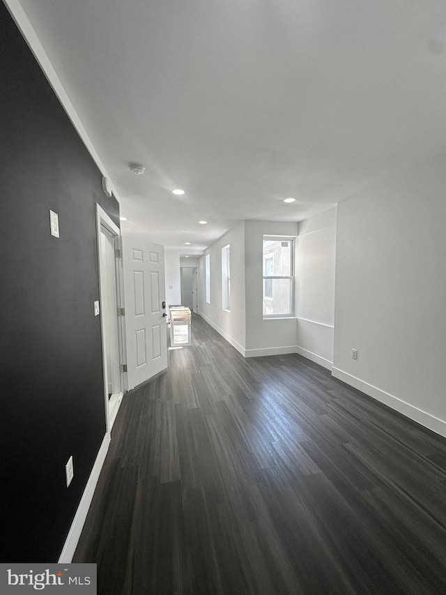 spare room with dark wood-type flooring