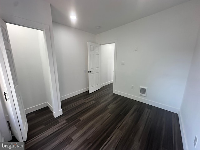 unfurnished bedroom featuring dark wood-type flooring