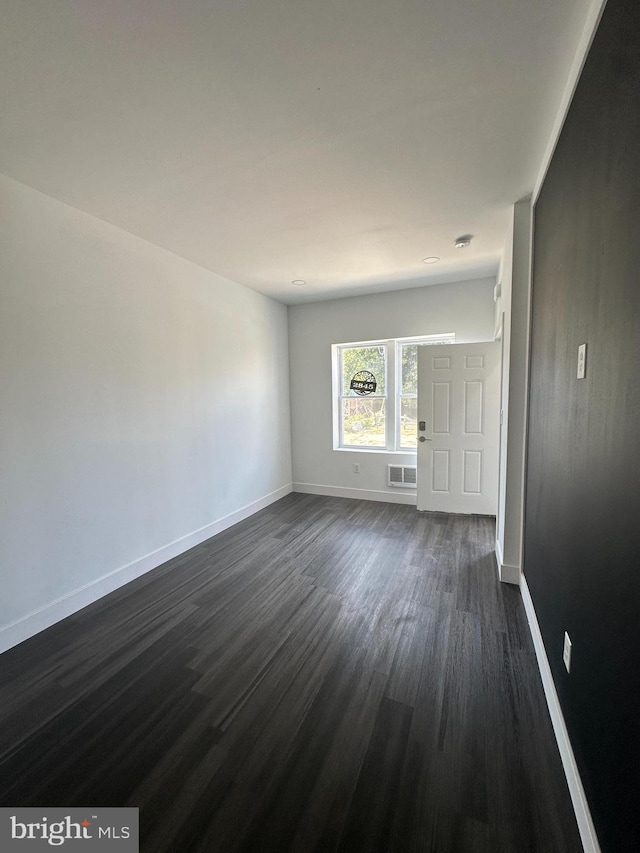 spare room featuring dark hardwood / wood-style floors