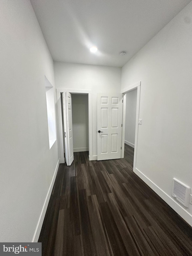 hallway with dark hardwood / wood-style floors