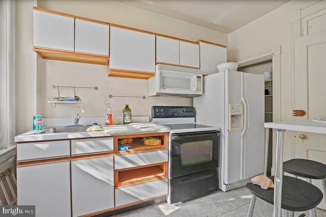 kitchen with white appliances and white cabinets