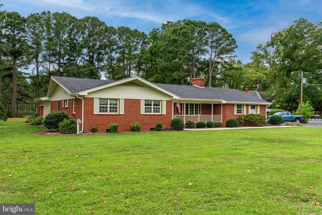 ranch-style house featuring a porch and a front yard