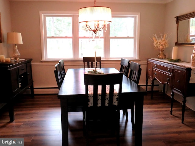 dining area with a baseboard heating unit, dark wood-type flooring, and a chandelier