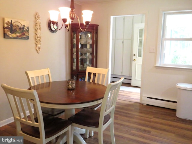 dining room featuring a baseboard radiator, a notable chandelier, and dark wood-type flooring