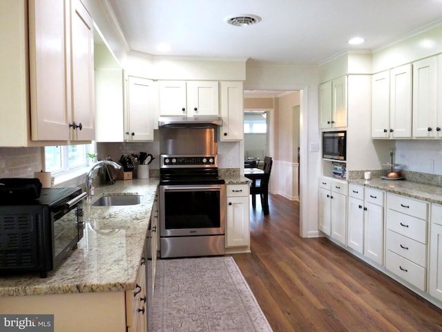 kitchen featuring sink, appliances with stainless steel finishes, hardwood / wood-style flooring, and white cabinets