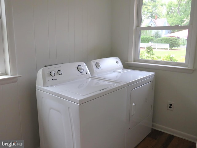 laundry area with dark hardwood / wood-style flooring and washer and clothes dryer