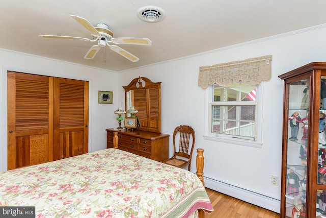 bedroom featuring light hardwood / wood-style flooring, a closet, crown molding, a baseboard heating unit, and ceiling fan