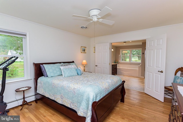 bedroom with light wood-type flooring, a baseboard heating unit, ceiling fan, and ornamental molding