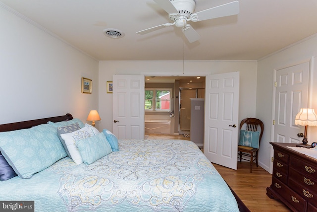 bedroom featuring ornamental molding, wood-type flooring, and ceiling fan