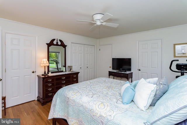 bedroom featuring ceiling fan, ornamental molding, and light wood-type flooring