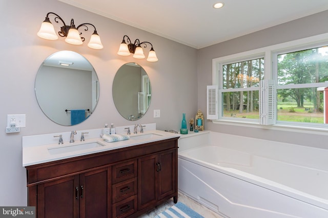 bathroom featuring crown molding, vanity, and a tub